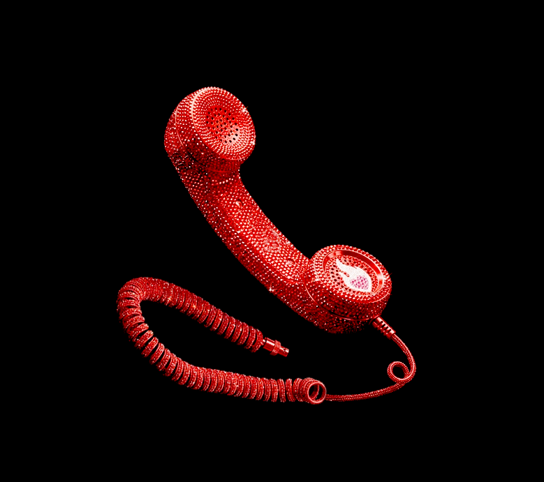 Bright red retro telephone handset completely covered in sparkling rhinestones, featuring a classic coiled cord and the iconic Cook For Your Crush logo, set against a solid black backdrop.