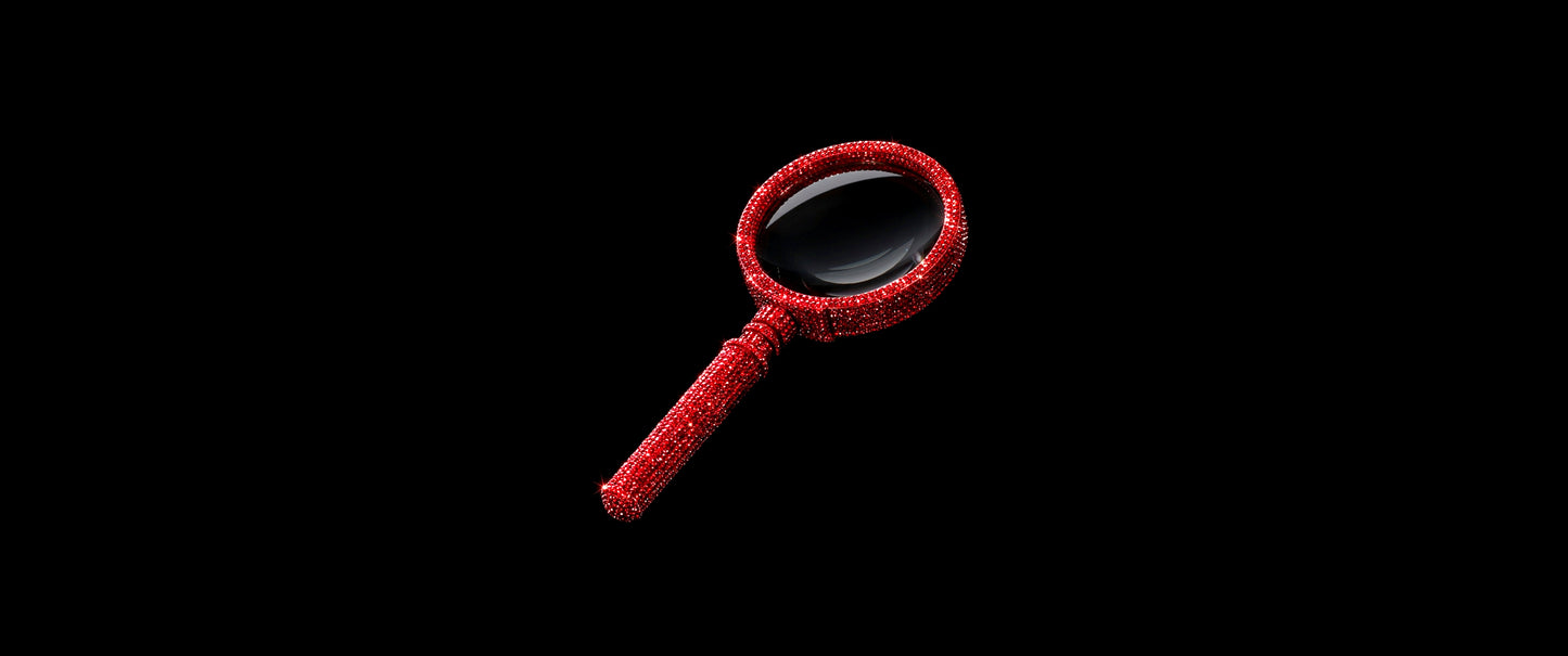 Luxurious magnifying glass fully encrusted with sparkling red crystals and rhinestones on a black background, symbolizing a premium search experience for Cook for your Crush.